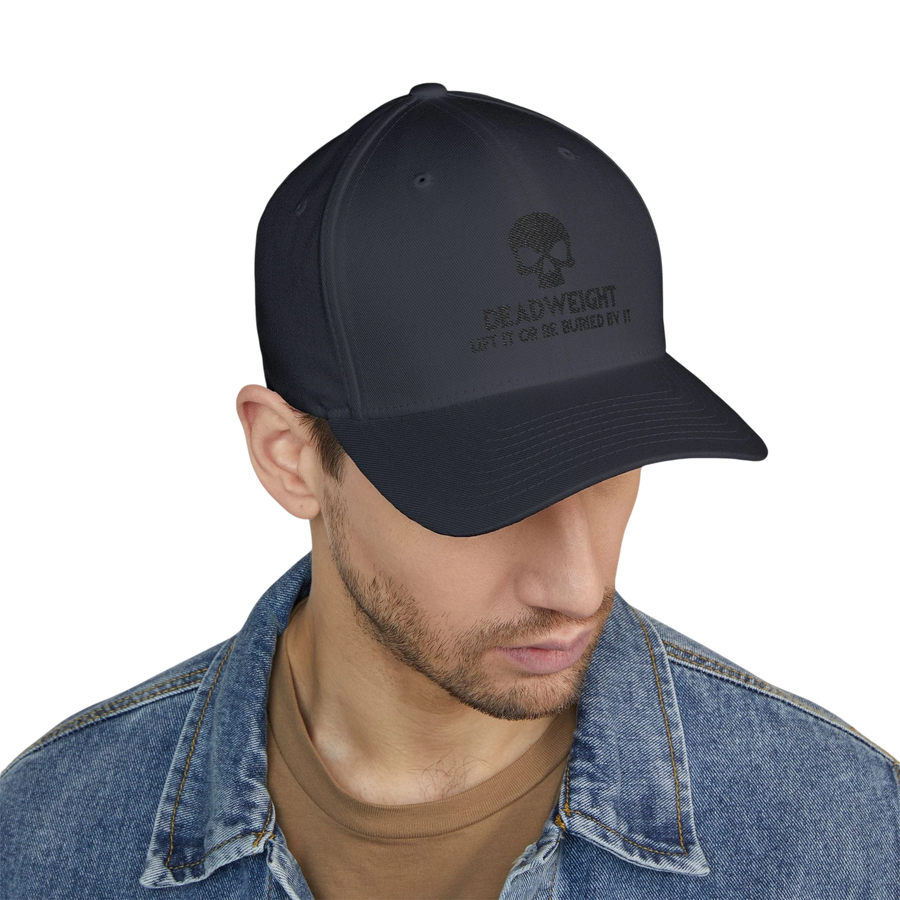 DailyThreadCo. black structured six-panel cap with Deadweight skull embroidery worn by a man in a denim jacket.