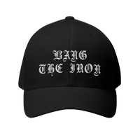 DailyThreadCo. black structured FlexFit cap with white gothic embroidery reading Bang the Iron on the front.