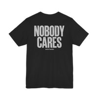 DailyThreadCo. black cotton graphic t-shirt featuring Nobody Cares Work Harder text in a distressed white font.