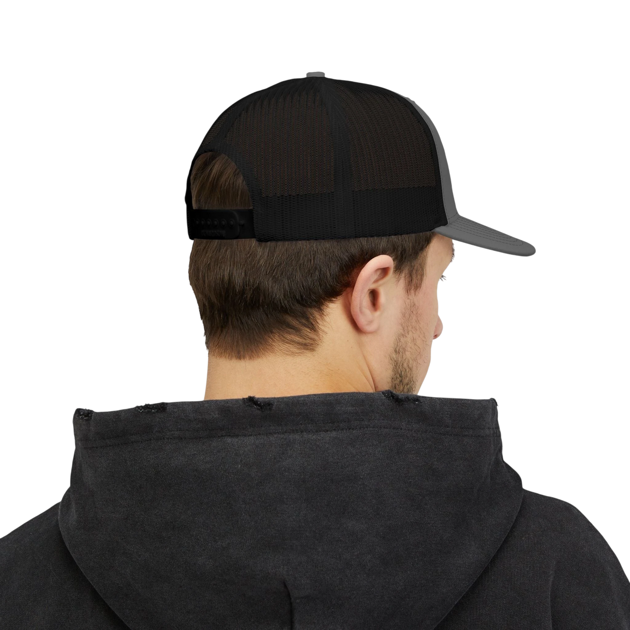 DailyThreadCo. black and grey trucker cap with mesh back worn by a man in a dark hoodie, rear view