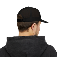 DailyThreadCo. black trucker cap with mesh back worn by a man in a dark hoodie, back view showing snapback closure.