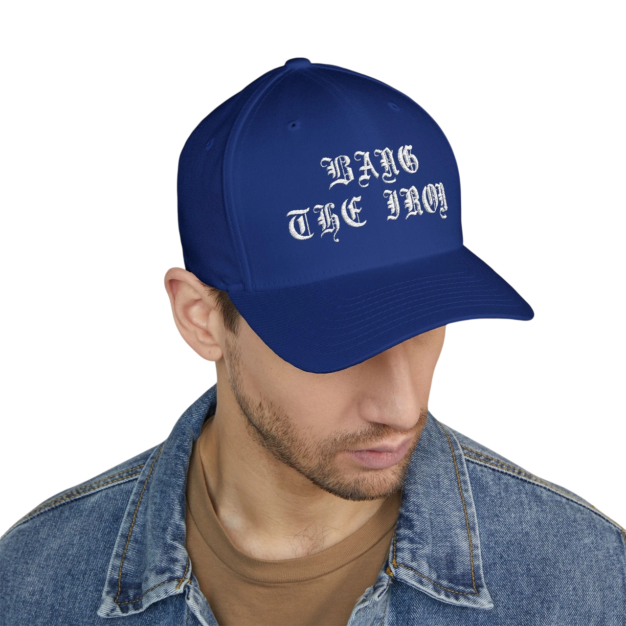 DailyThreadCo. blue structured FlexFit cap with white Bang the Iron gothic embroidery worn by a man in a denim jacket.