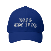 DailyThreadCo. blue structured FlexFit cap with white gothic Bang the Iron embroidery on the front panel.