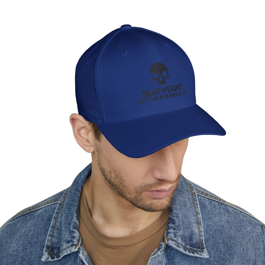 DailyThreadCo. blue structured cap with skull embroidery and Deadweight text worn by a man in a denim jacket.