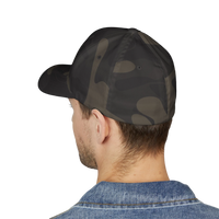 DailyThreadCo. structured camo baseball cap with a closed back, worn by a man in a denim jacket.