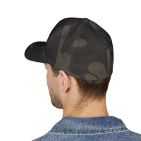 DailyThreadCo. structured camo FlexFit cap worn by a man, showing the closed-back design and six-panel construction.