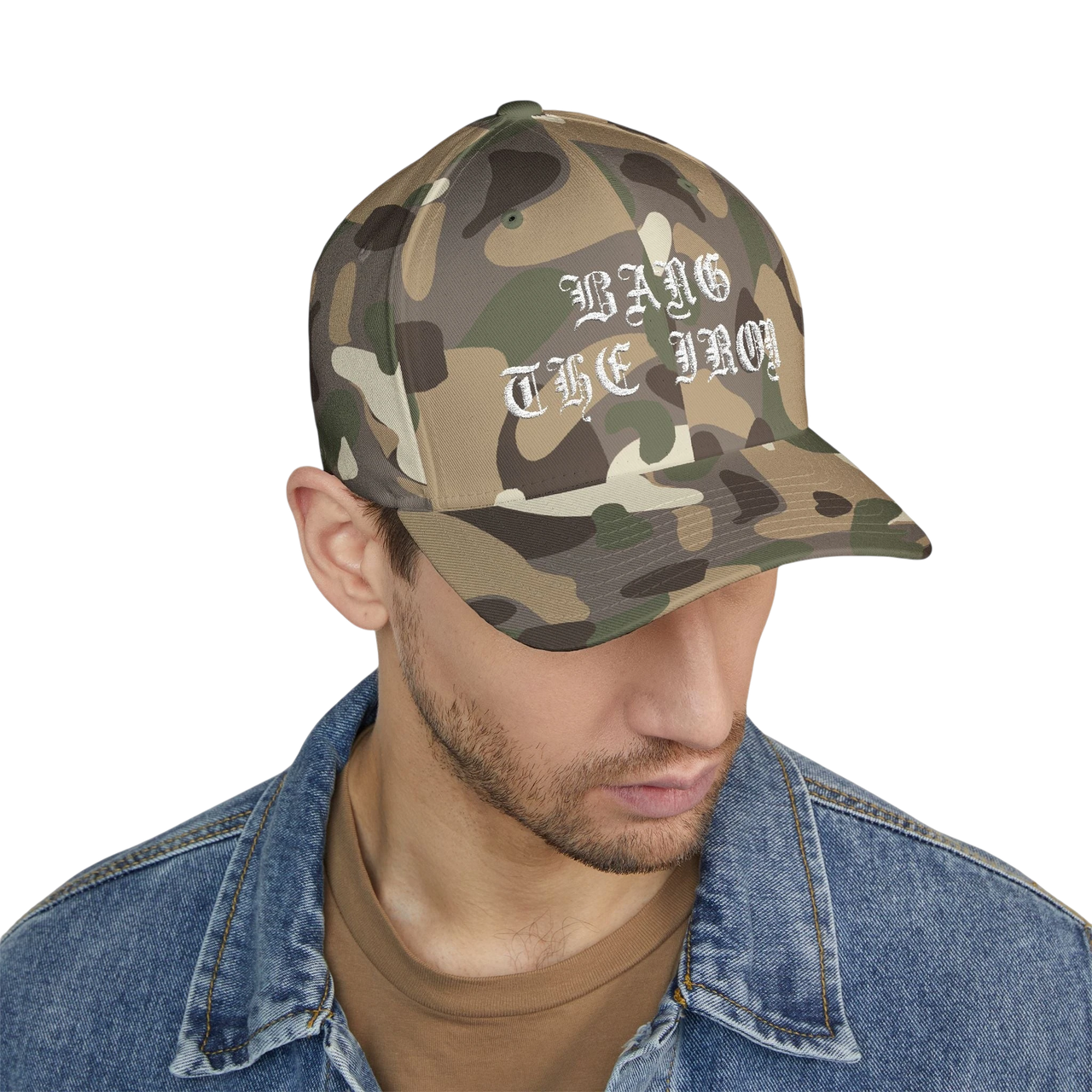 DailyThreadCo. camo FlexFit cap with white gothic Bang the Iron embroidery, worn by a man in a denim jacket.