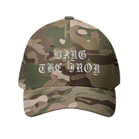 DailyThreadCo. camouflage FlexFit cap featuring white gothic embroidery reading Bang the Iron on the front panel.