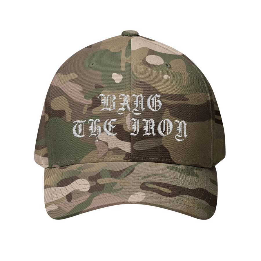 DailyThreadCo. camouflage FlexFit cap featuring white gothic embroidery reading Bang the Iron on the front panel.