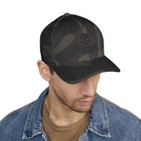 DailyThreadCo. black camo structured cap with embroidered skull logo and Deadweight text worn by a man in denim jacket