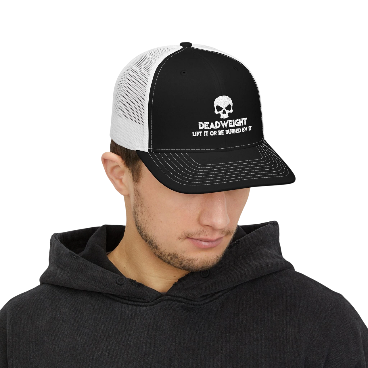 DailyThreadCo. black and white trucker cap with a skull logo and Deadweight text worn by a man in a black hoodie.