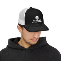 DailyThreadCo. black and white trucker cap with a skull logo and Deadweight text worn by a man in a black hoodie.