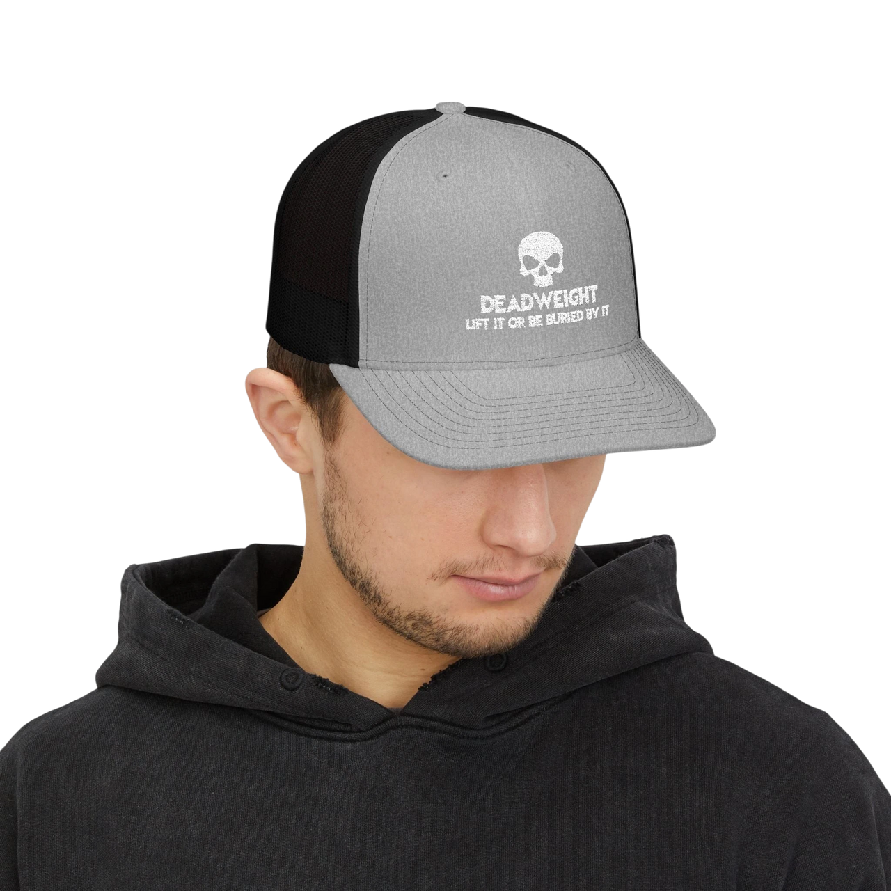 DailyThreadCo. grey and black trucker cap with a white skull Deadweight logo worn by a man in a black hoodie.