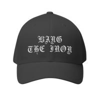 DailyThreadCo. structured FlexFit cap in dark grey twill with white gothic Bang the Iron embroidery on the front.