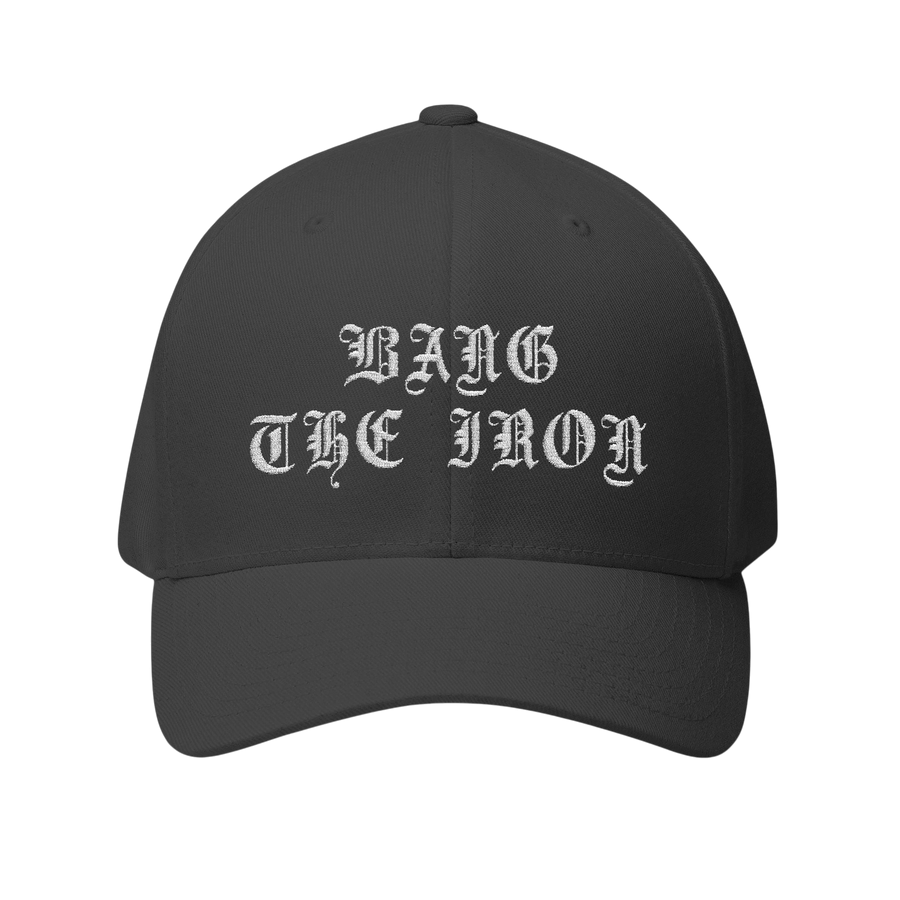 DailyThreadCo. structured FlexFit cap in dark grey twill with white gothic Bang the Iron embroidery on the front.