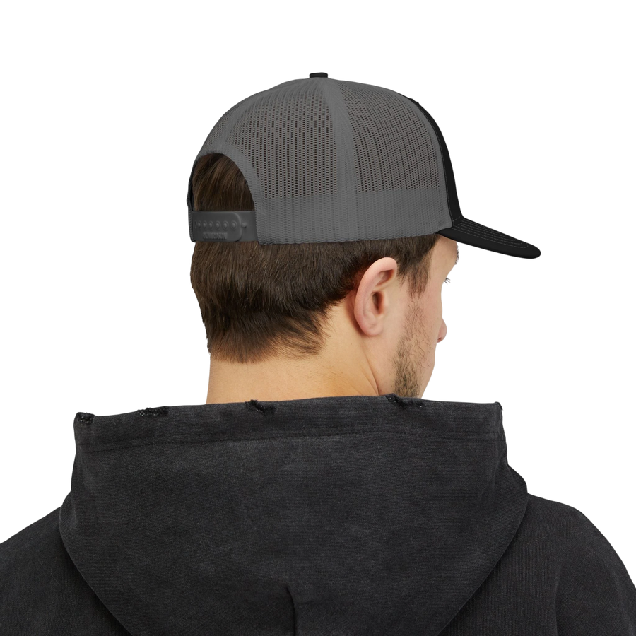 DailyThreadCo. grey and black mesh back trucker cap worn by a man from the back view