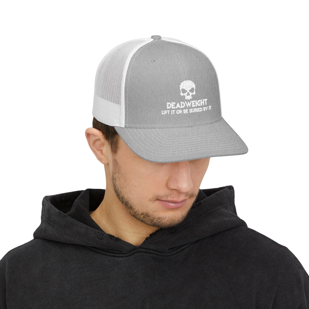 DailyThreadCo. grey and white trucker cap with a skull logo worn by a man in a black hoodie.