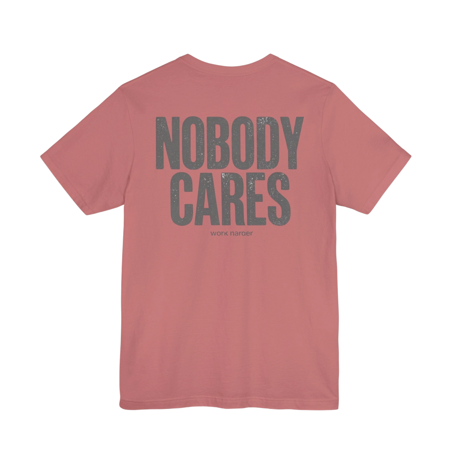 DailyThreadCo. dusty rose graphic t-shirt with Nobody Cares text in grey on the back, made from soft cotton.