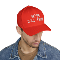 DailyThreadCo. red structured FlexFit cap with white Bang the Iron gothic embroidery worn by a man in a denim jacket.