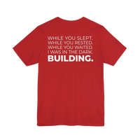 DailyThreadCo. red cotton t-shirt featuring a bold white typographic manifesto print on the back.