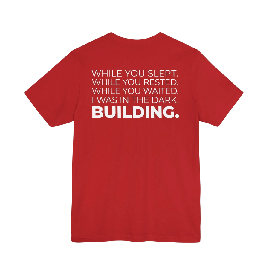 DailyThreadCo. red cotton t-shirt featuring a bold white typographic manifesto print on the back.