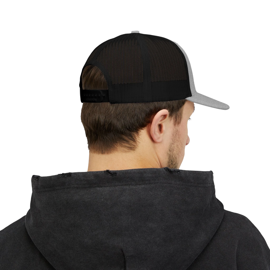 DailyThreadCo. trucker cap with black mesh back and grey brim worn by a man in a dark hoodie, back view.