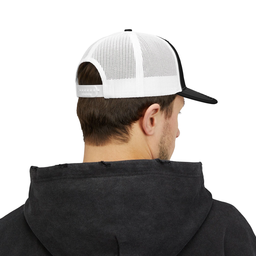 DailyThreadCo. trucker cap with white mesh back and adjustable snapback, worn by a man in a black hoodie.