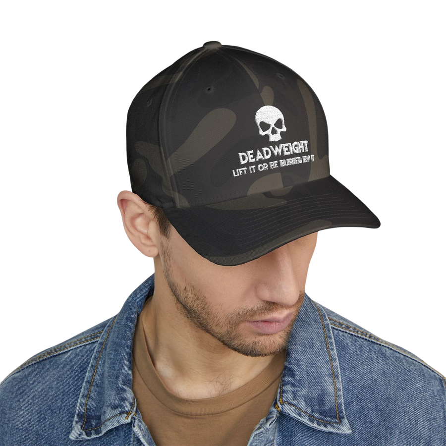 deadweightgymapparel. camo flexfit cap featuring a distressed skull embroidery and Deadweight text on a model.